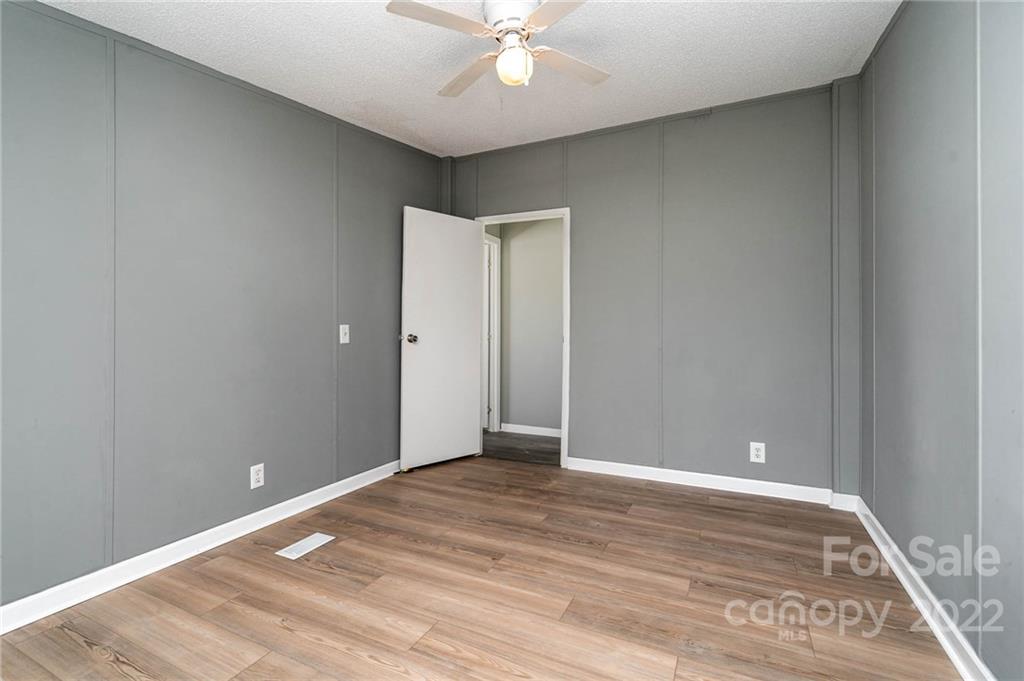 4289 Henry Dellinger Road Maiden, NC 28650 - Photo 34 of 42 a view of an empty room with wooden floor
