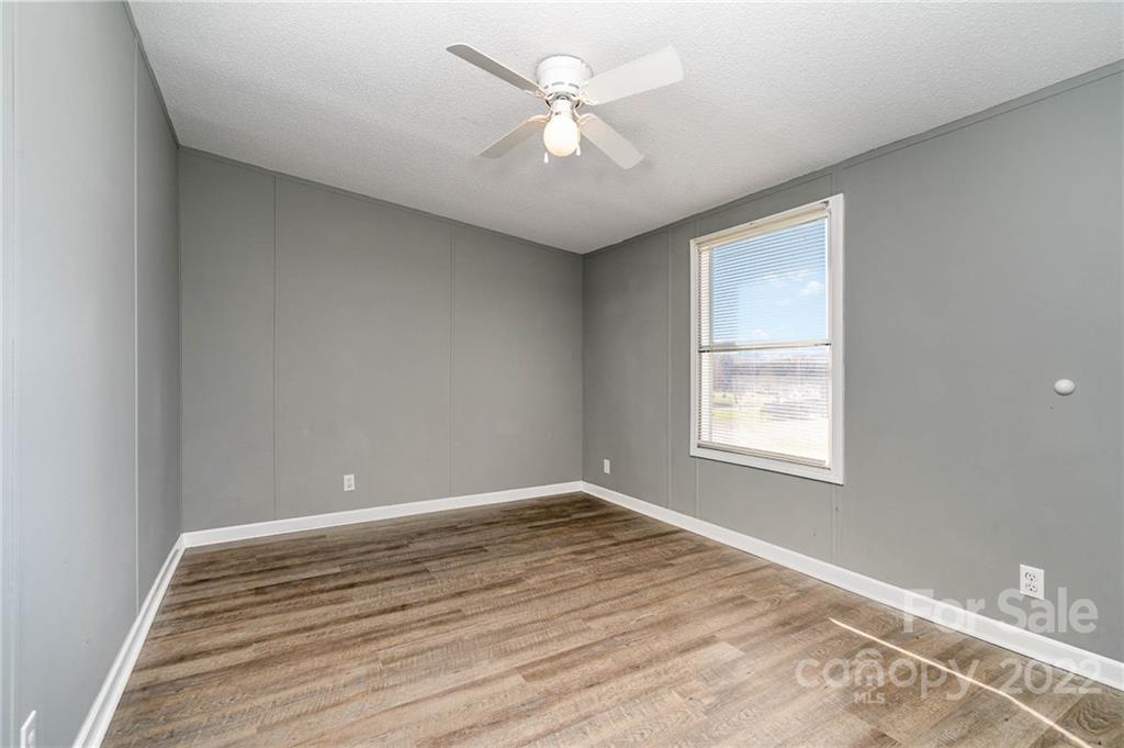4289 Henry Dellinger Road Maiden, NC 28650 - Photo 4 of 42 wooden floor in an empty room with a window