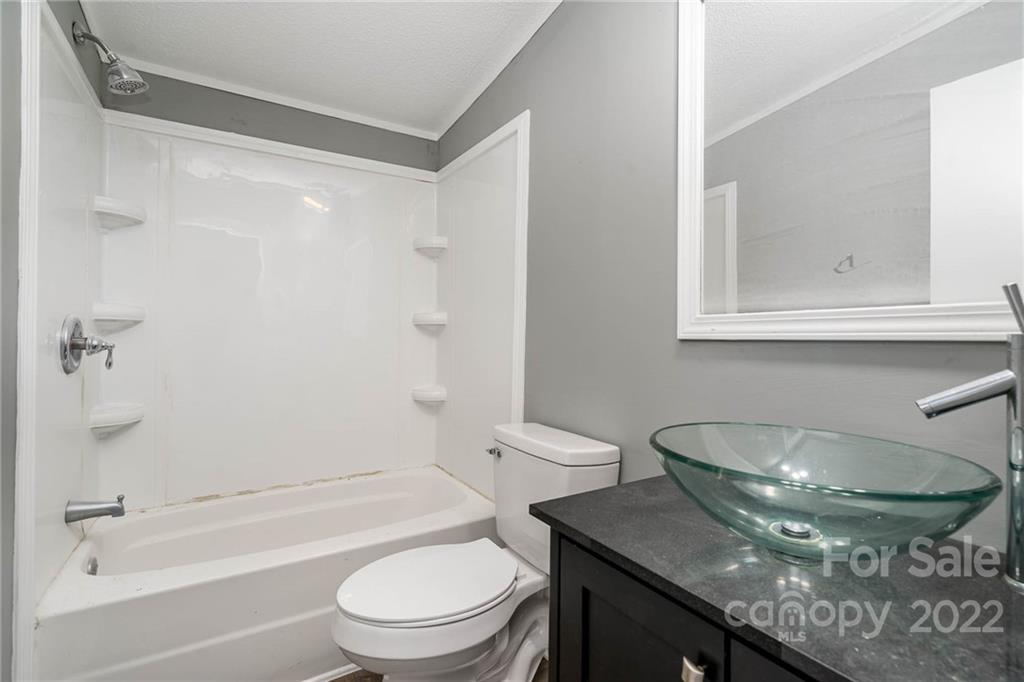 4289 Henry Dellinger Road Maiden, NC 28650 - Photo 5 of 42 a bathroom with a granite countertop sink toilet and shower