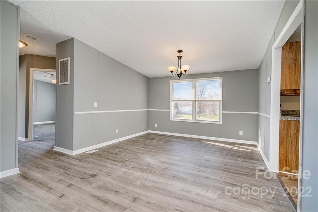 4289 Henry Dellinger Road Maiden, NC 28650 - Photo 7 of 42 wooden floor in an empty room with a window
