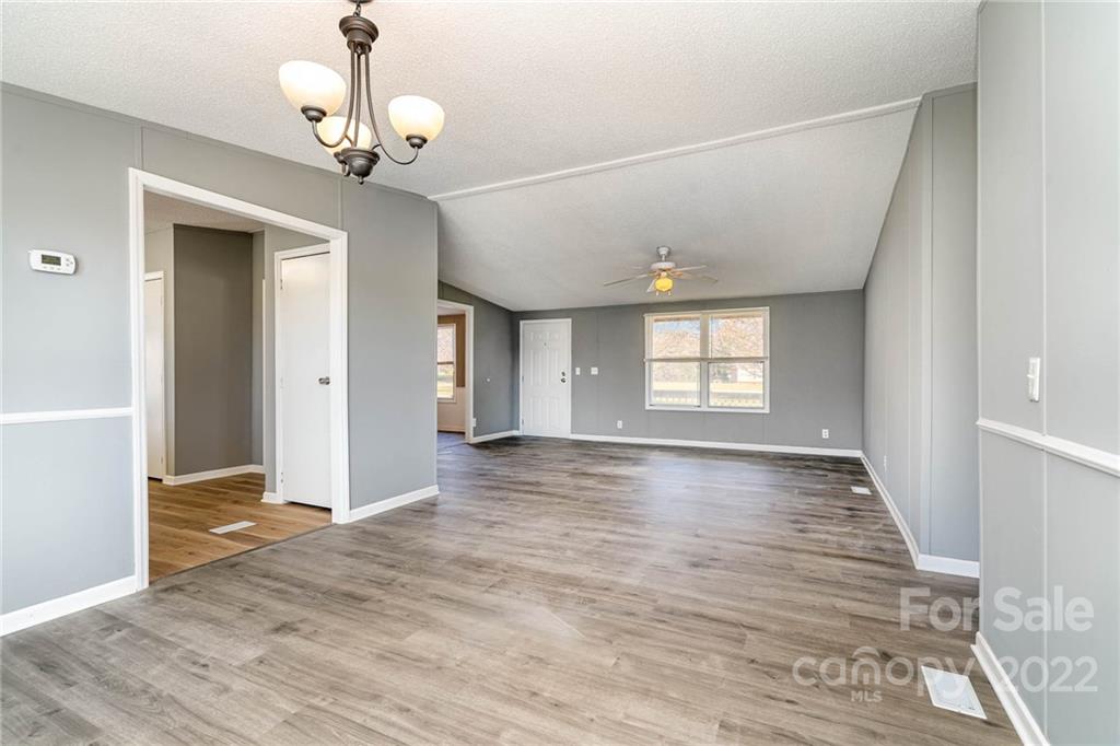 4289 Henry Dellinger Road Maiden, NC 28650 - Photo 8 of 42 a view of an empty room with wooden floor and a window