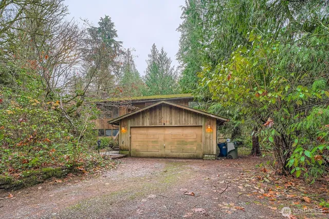 a view of backyard of house with large trees