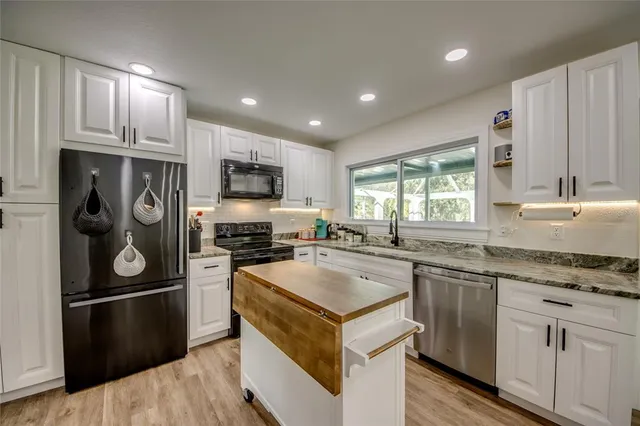 a kitchen with a sink stove and refrigerator