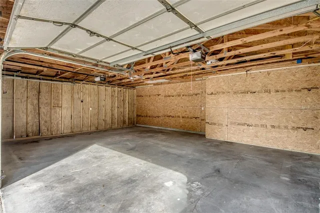 a kitchen with a refrigerator and white cabinets