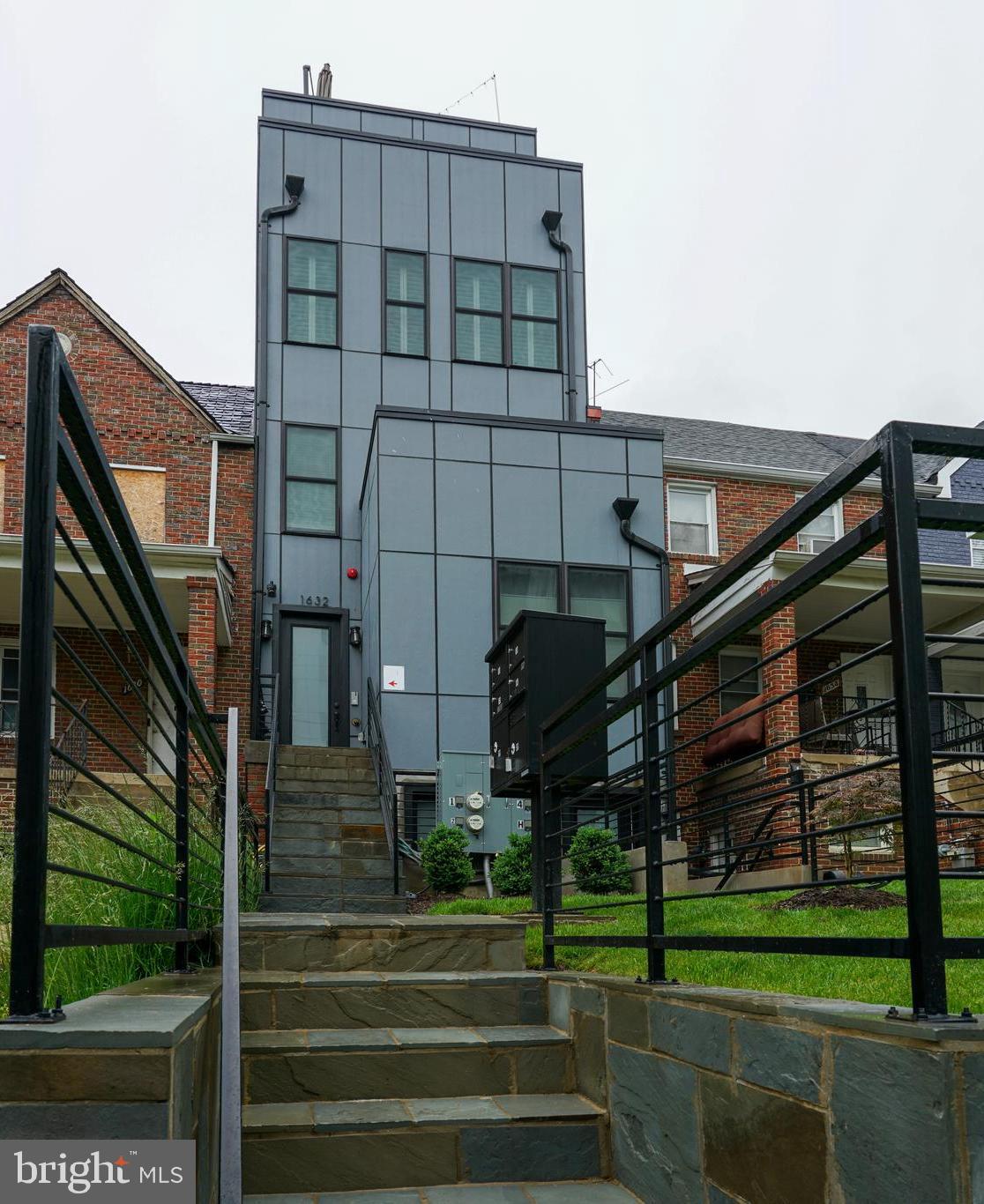 a view of a tall building next to a yard