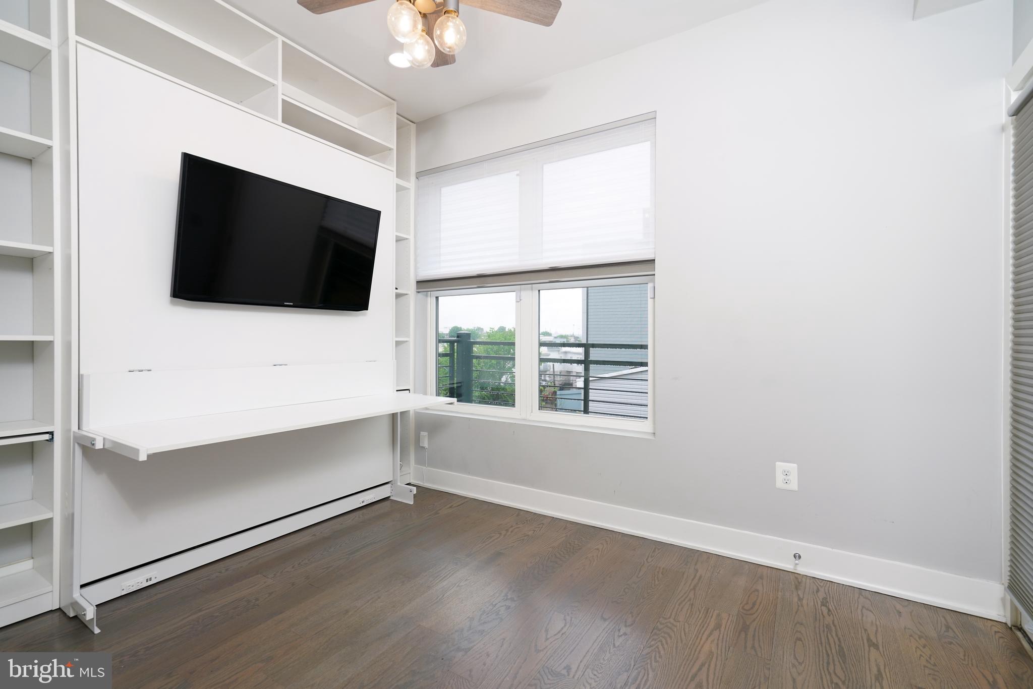 1632 K Street Northeast, Unit PH Washington, DC 20002 - Photo 30 of 69 a view of an empty room with a flat screen tv