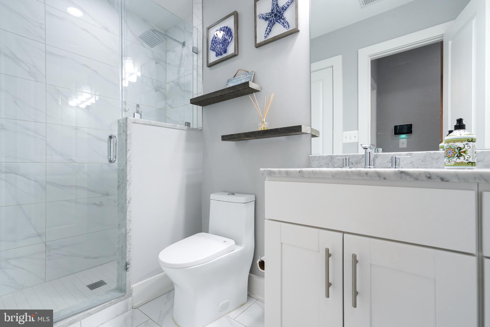 1632 K Street Northeast, Unit PH Washington, DC 20002 - Photo 34 of 69 a bathroom with a sink a toilet and a shower