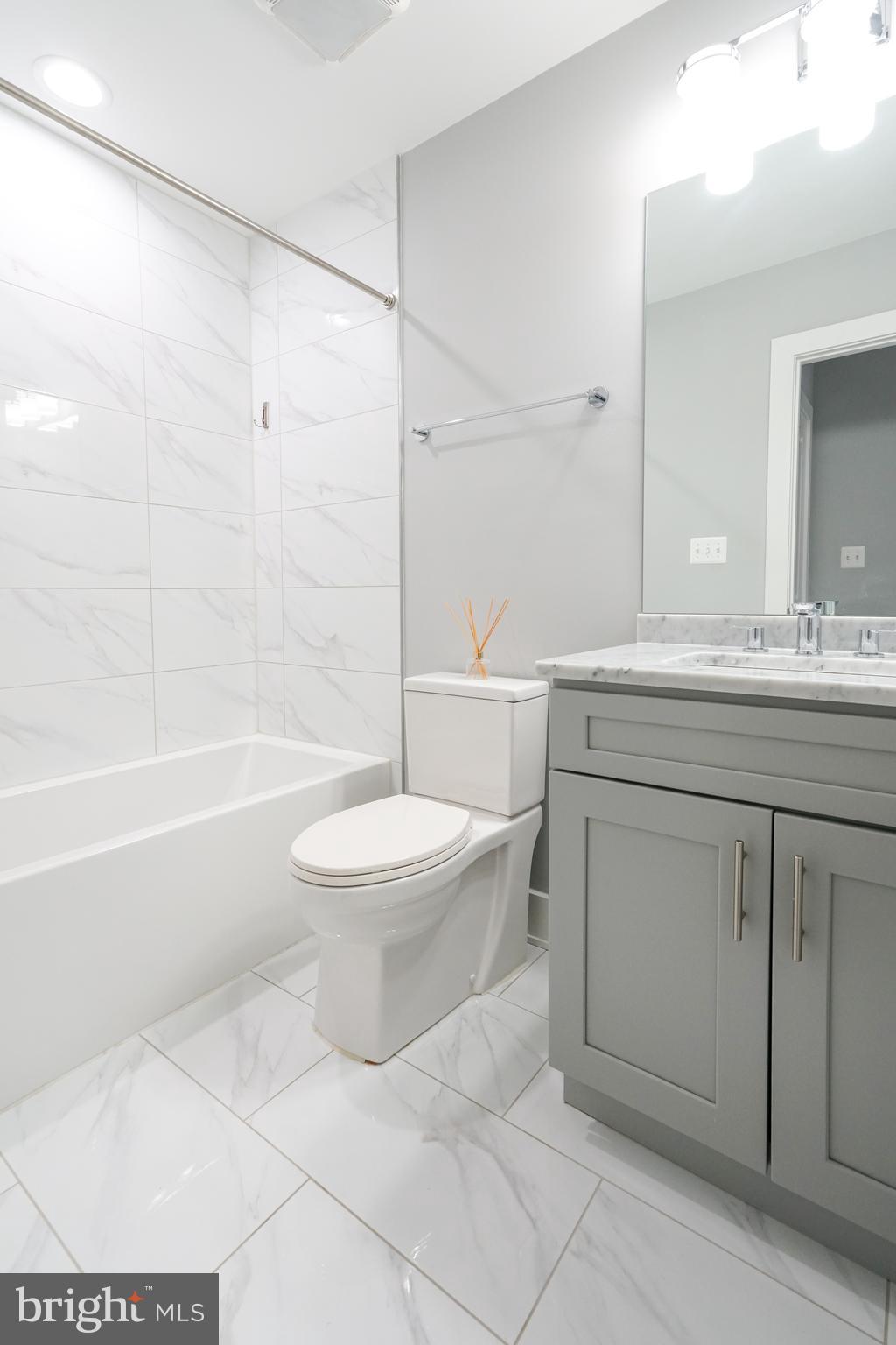 1632 K Street Northeast, Unit PH Washington, DC 20002 - Photo 37 of 69 a bathroom with a sink a toilet and a bathtub