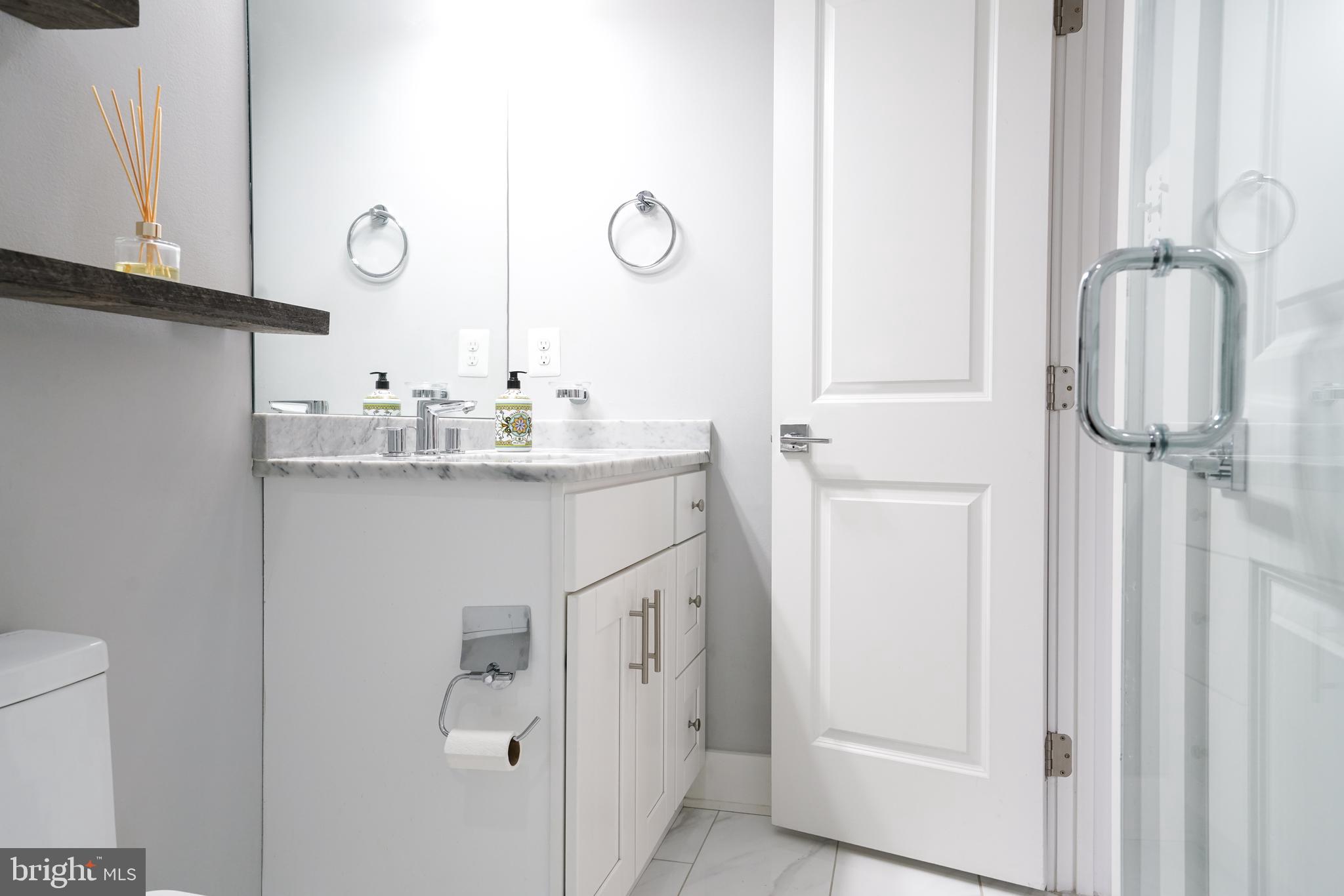 1632 K Street Northeast, Unit PH Washington, DC 20002 - Photo 41 of 69 a bathroom with a sink and mirror with toilet
