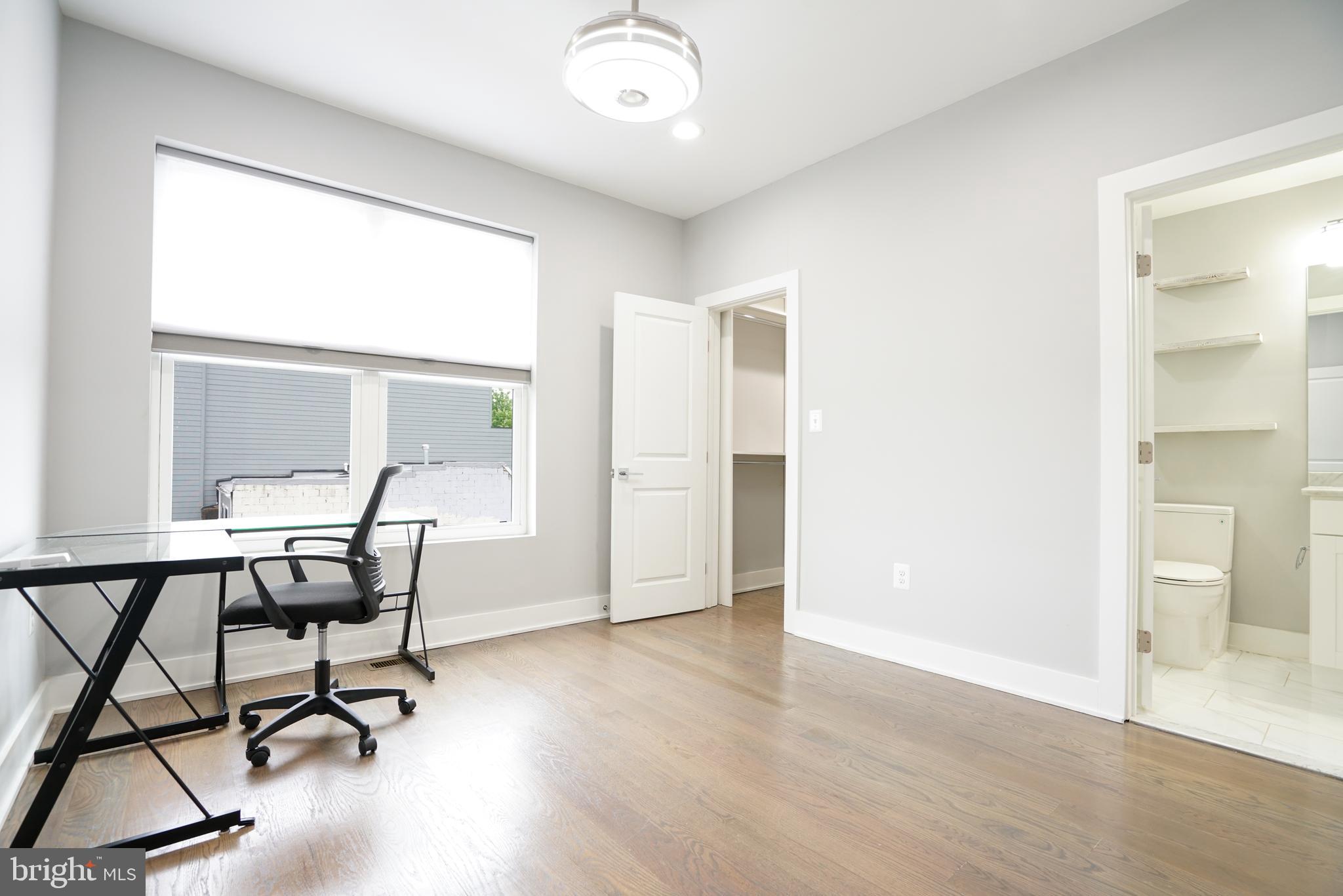 1632 K Street Northeast, Unit PH Washington, DC 20002 - Photo 45 of 69 a view of a workspace with furniture and a window