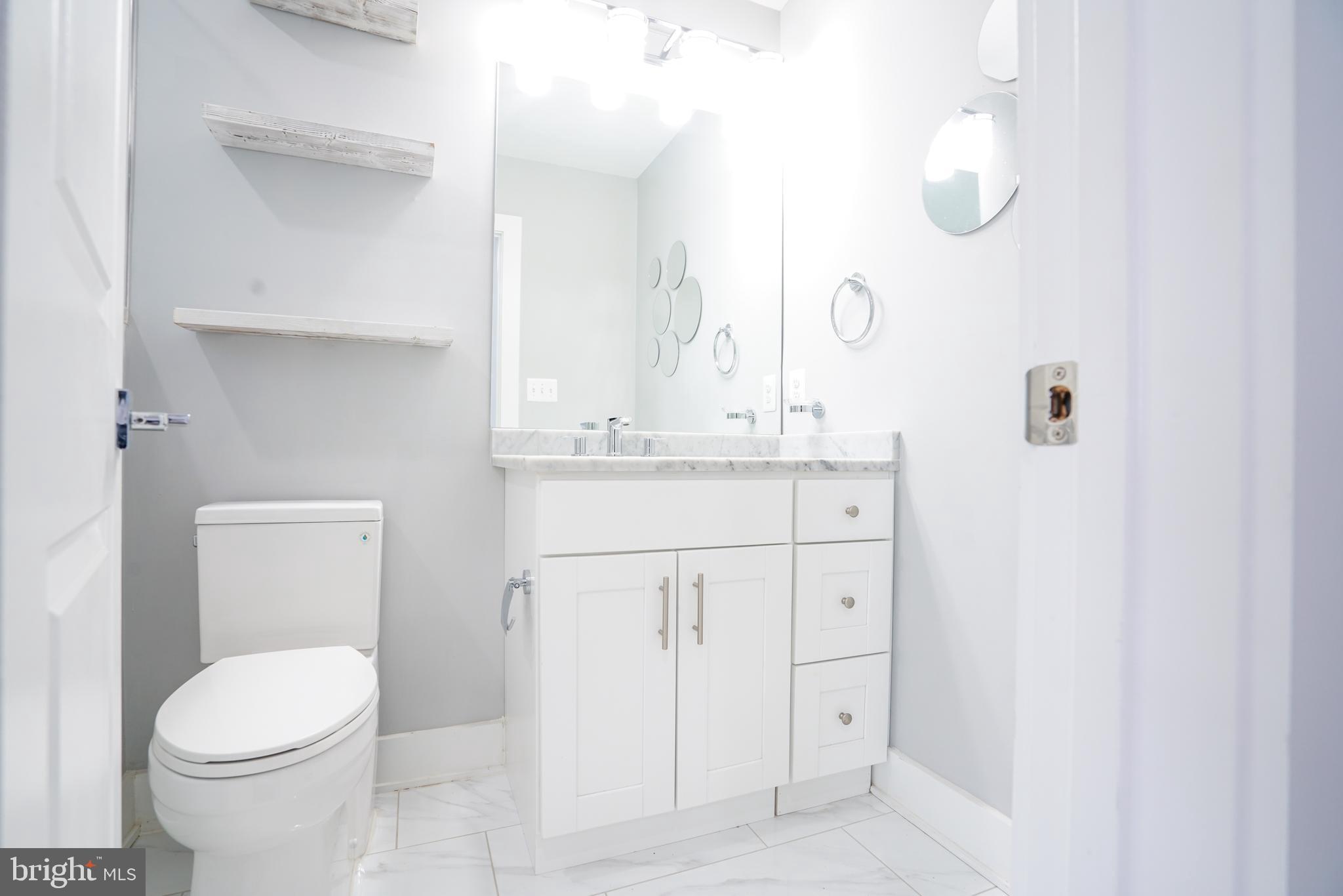 1632 K Street Northeast, Unit PH Washington, DC 20002 - Photo 49 of 69 a bathroom with a sink a toilet and a mirror