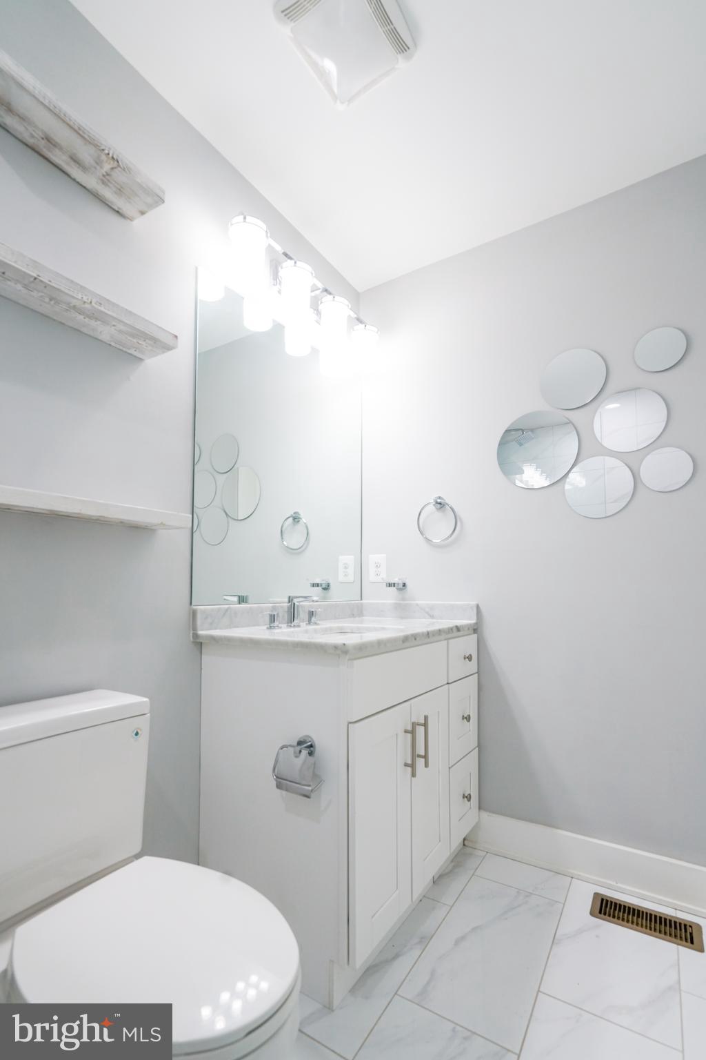 1632 K Street Northeast, Unit PH Washington, DC 20002 - Photo 50 of 69 a bathroom with a toilet a sink and mirror