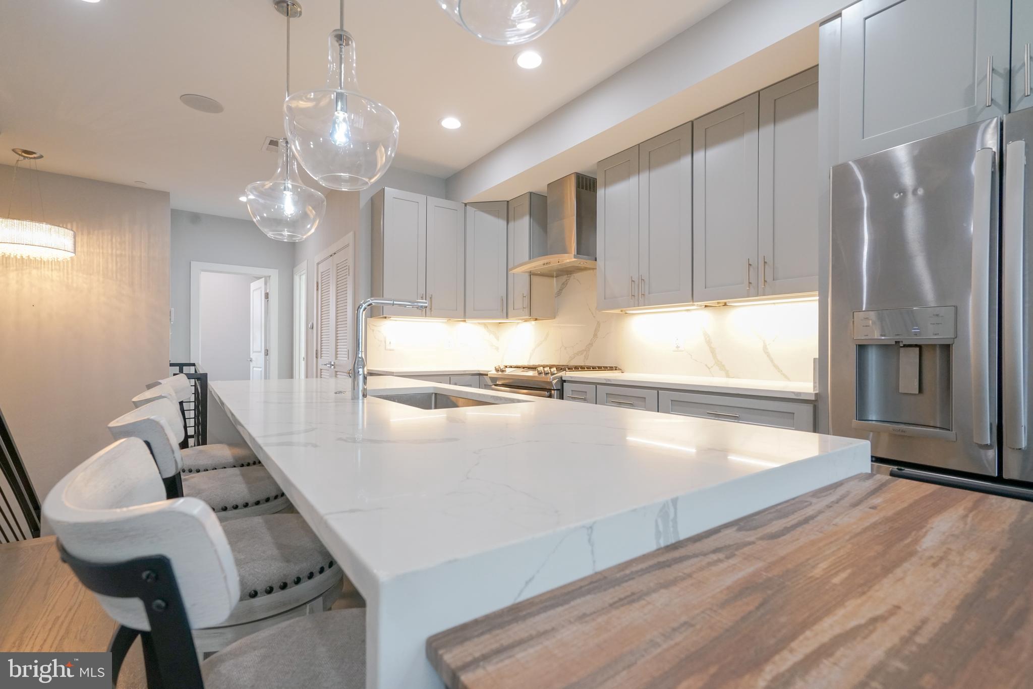 1632 K Street Northeast, Unit PH Washington, DC 20002 - Photo 5 of 69 a kitchen with stainless steel appliances granite countertop a refrigerator a sink and a stove