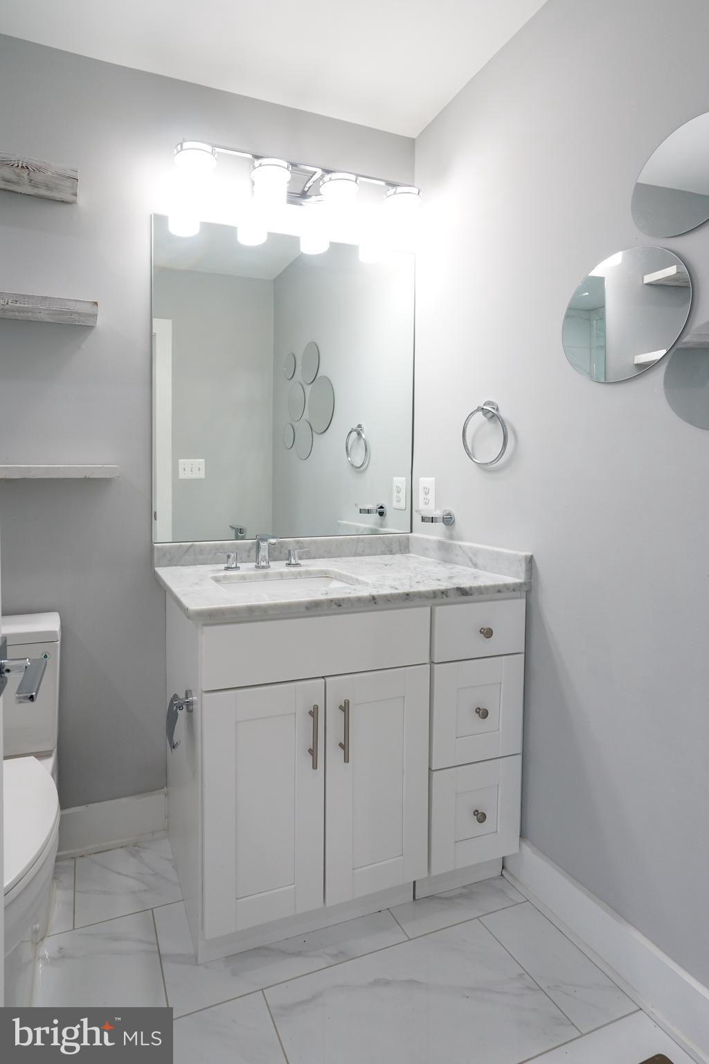 1632 K Street Northeast, Unit PH Washington, DC 20002 - Photo 53 of 69 a bathroom with a sink a toilet and a mirror