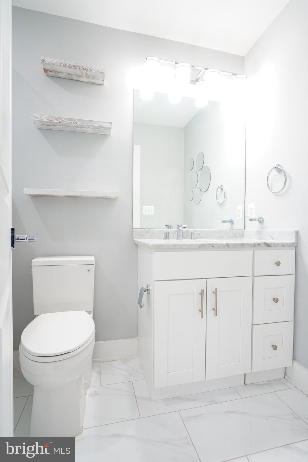 1632 K Street Northeast, Unit PH Washington, DC 20002 - Photo 54 of 69 a bathroom with a toilet sink and mirror