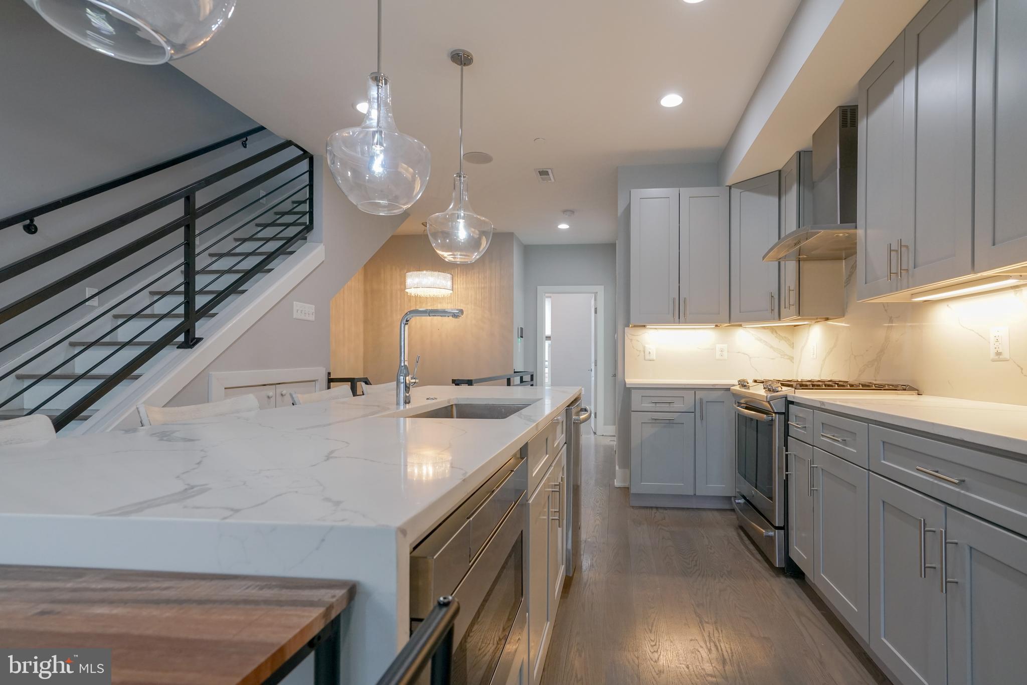 1632 K Street Northeast, Unit PH Washington, DC 20002 - Photo 9 of 69 a kitchen with a sink stainless steel appliances and cabinets