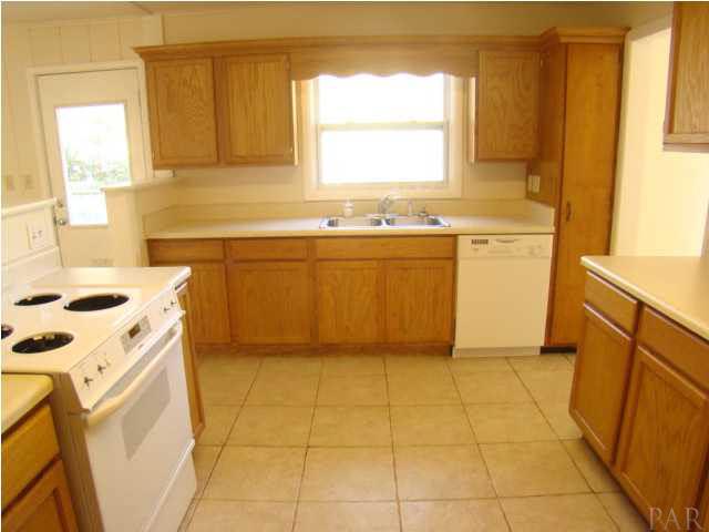 4810 Creighton Road Pensacola, FL 32504 - Photo 5 of 22 Tiled kitchen with updated cabinets, appliances, & countertops