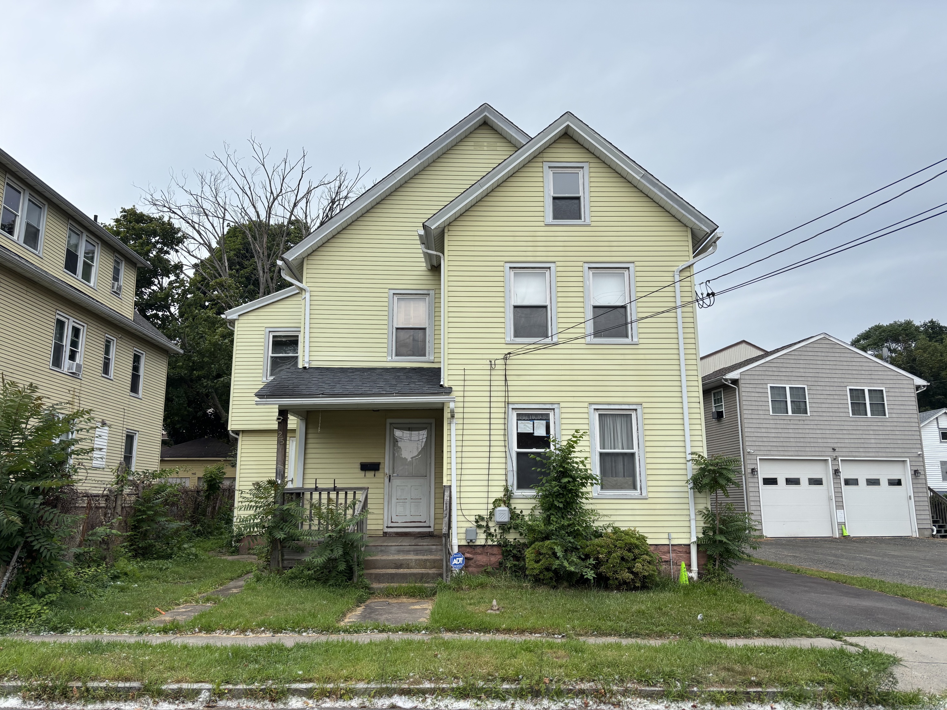 25 Clinton Avenue Middletown, CT 06457 - Photo 1 of 31 a front view of a house with a yard and trees