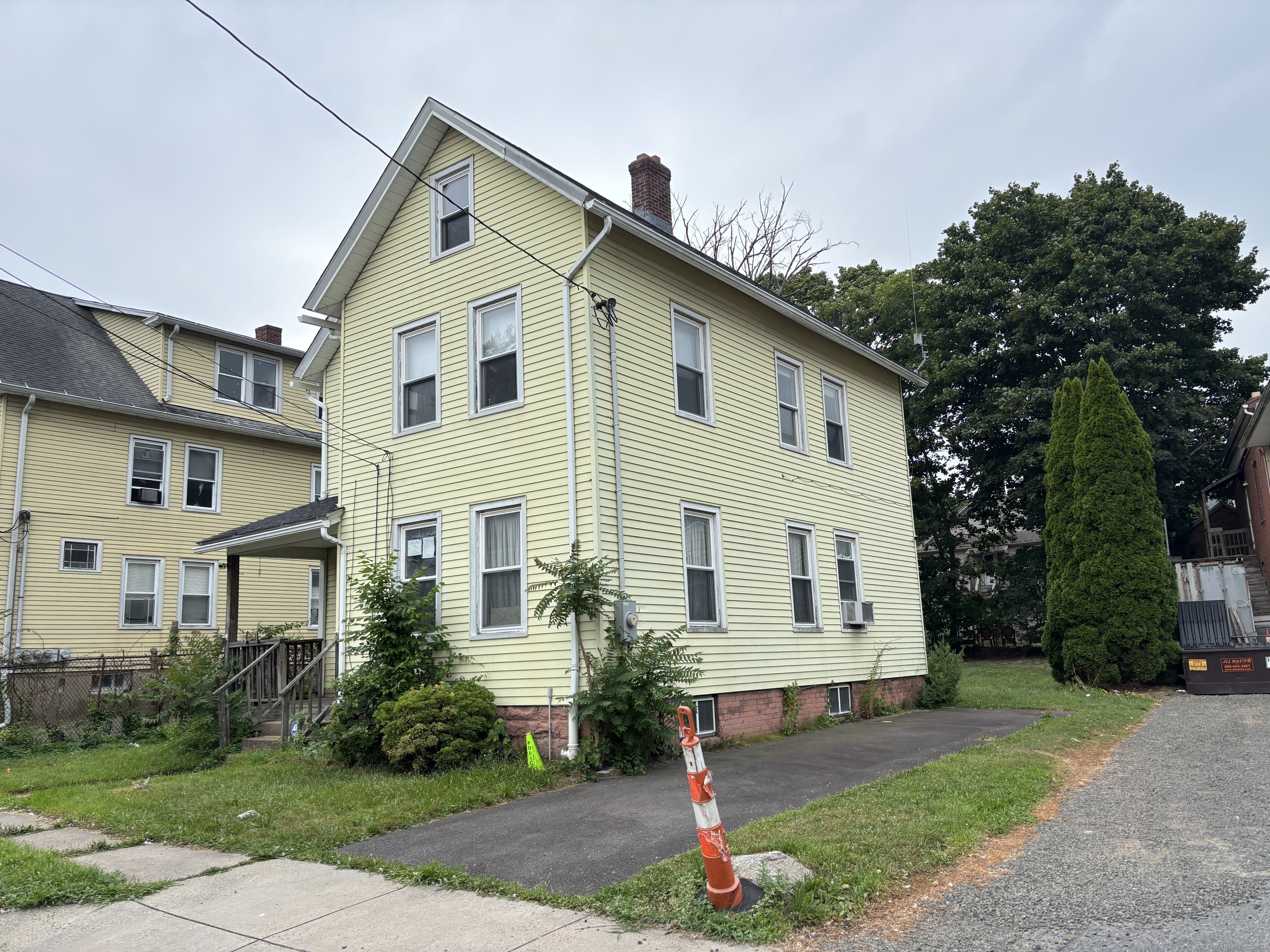 25 Clinton Avenue Middletown, CT 06457 - Photo 2 of 31 a front view of a house with a yard and garage