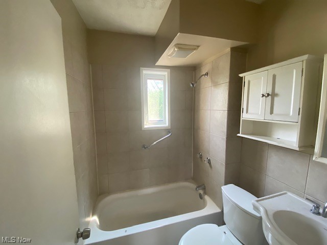 921 Rudyard Road Cleveland, OH 44110 - Photo 14 of 31 Full bathroom featuring sink, tile walls, and tiled shower / bath combo
