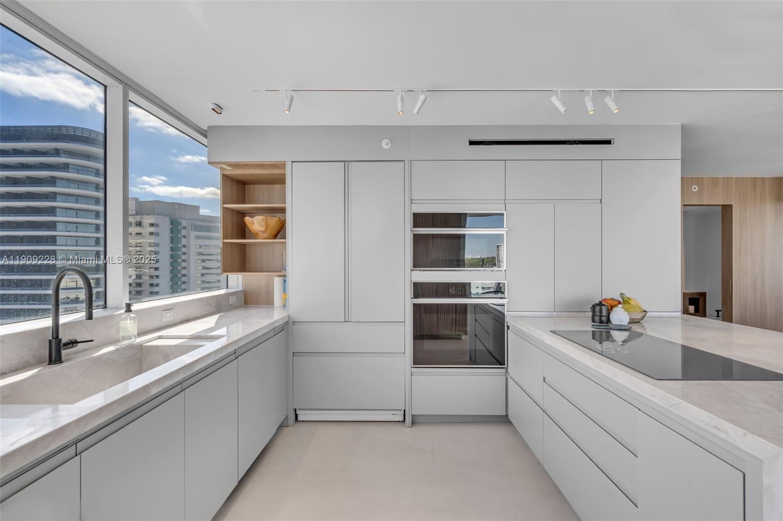 3411 Indian Creek Drive, Unit 1201 Miami Beach, FL 33140 - Photo 22 of 68 a kitchen with a sink and cabinets