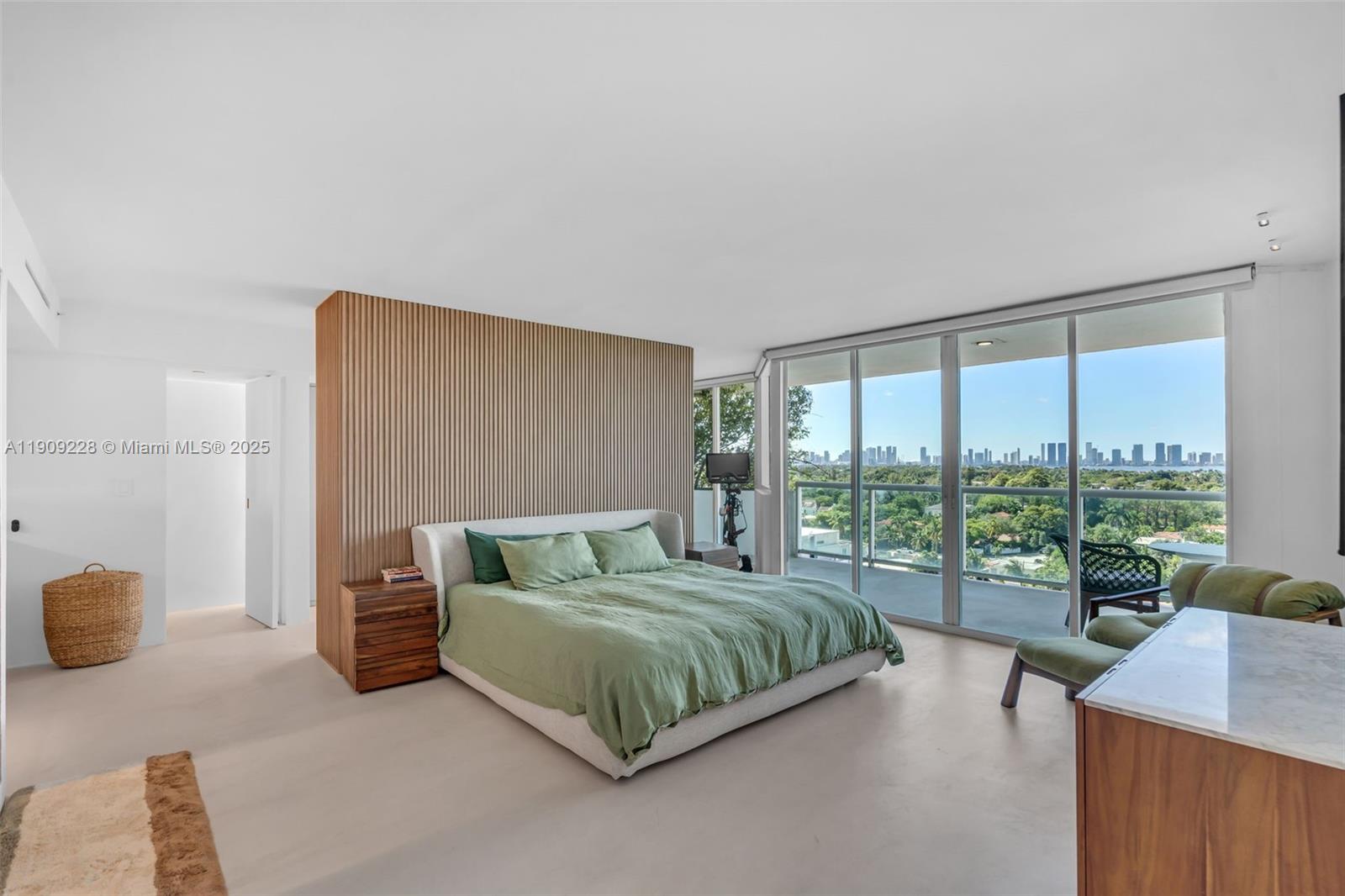 3411 Indian Creek Drive, Unit 1201 Miami Beach, FL 33140 - Photo 24 of 68 a bedroom with a bed and glass door