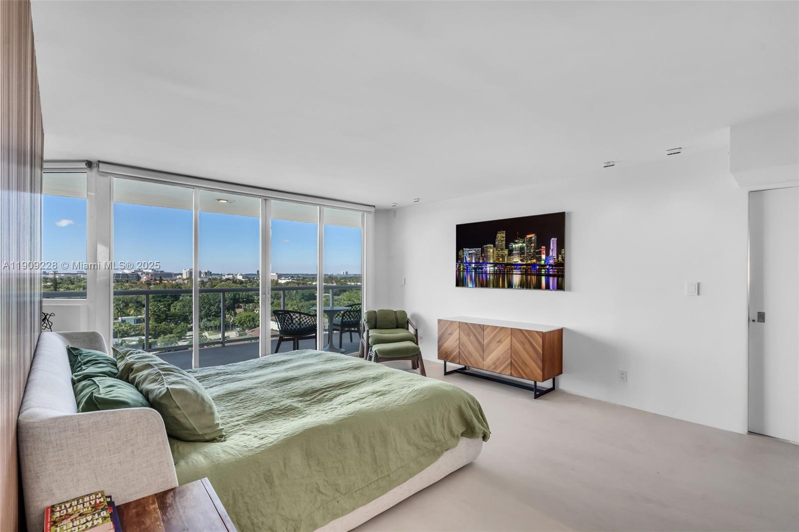 3411 Indian Creek Drive, Unit 1201 Miami Beach, FL 33140 - Photo 25 of 68 a bedroom with a bed and a couch next to a window