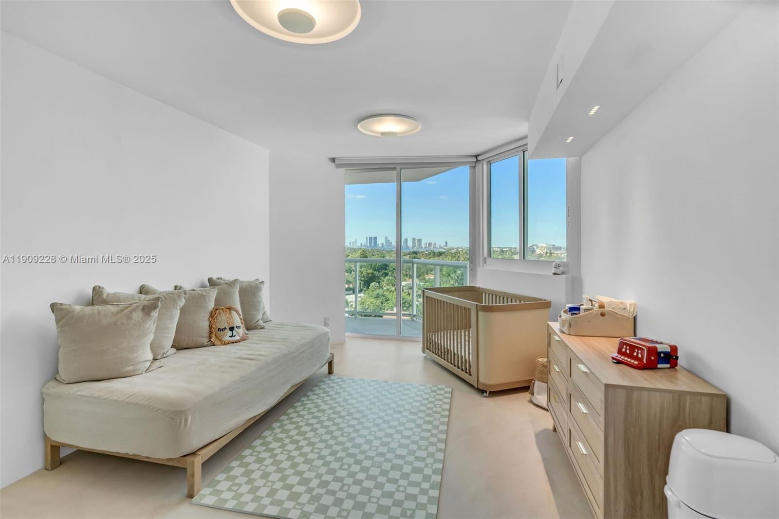 3411 Indian Creek Drive, Unit 1201 Miami Beach, FL 33140 - Photo 31 of 68 a bedroom with furniture and a large window