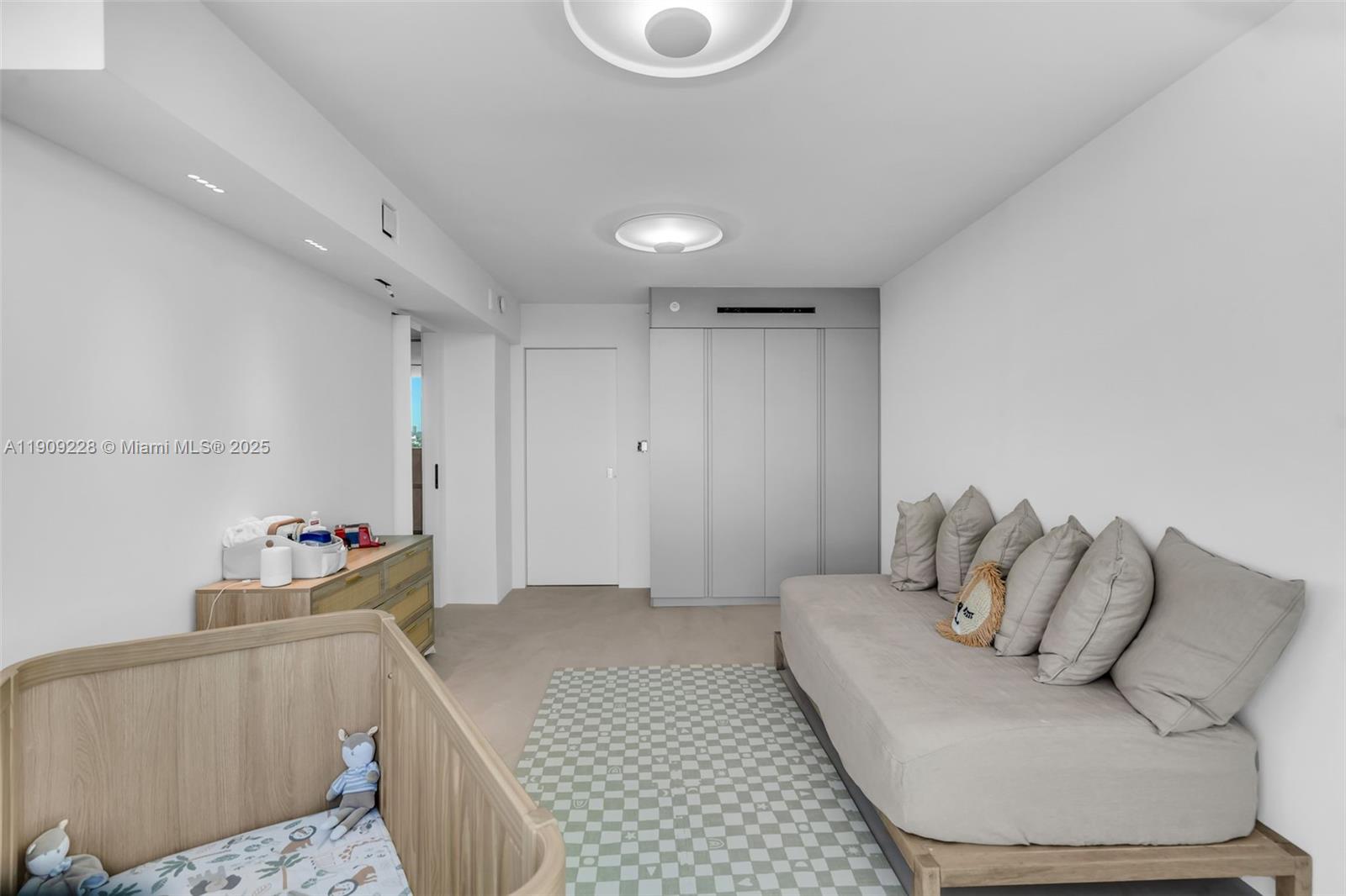 3411 Indian Creek Drive, Unit 1201 Miami Beach, FL 33140 - Photo 32 of 68 a bedroom with furniture and a couch