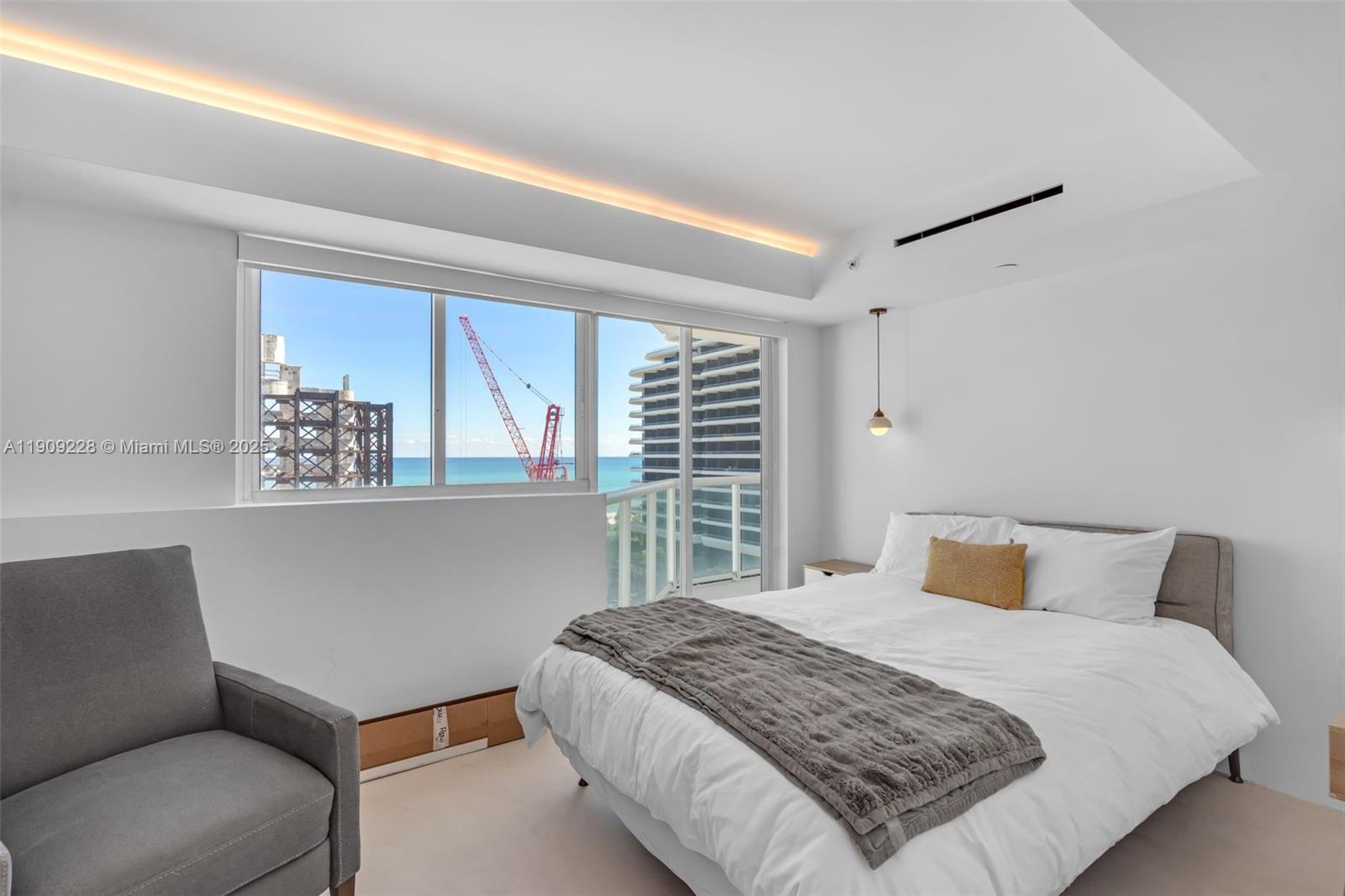 3411 Indian Creek Drive, Unit 1201 Miami Beach, FL 33140 - Photo 35 of 68 a bedroom with a large bed and a window