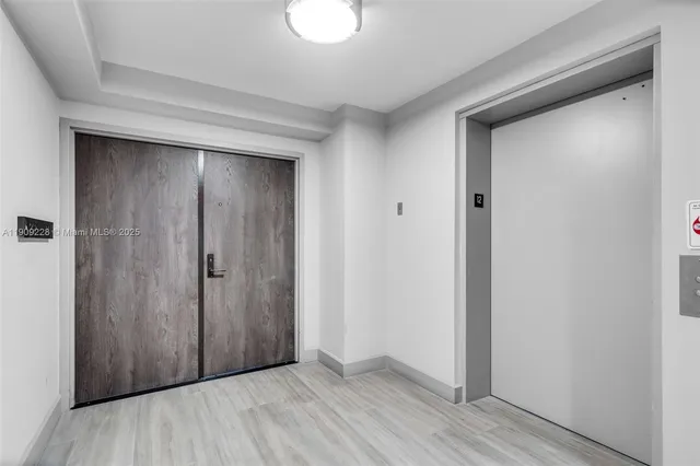 a view of balcony with two chairs and a potted plant