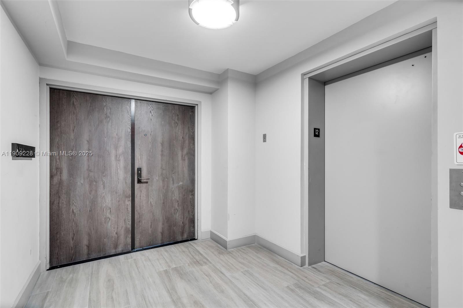 3411 Indian Creek Drive, Unit 1201 Miami Beach, FL 33140 - Photo 44 of 68 a view of an empty room with wooden floor and closet