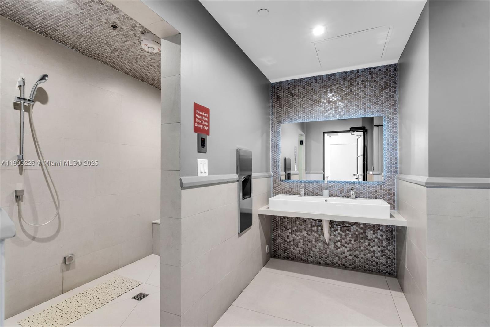 3411 Indian Creek Drive, Unit 1201 Miami Beach, FL 33140 - Photo 51 of 68 a bathroom with a double vanity sink and mirror