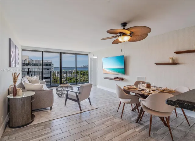 a living room with furniture a rug and a window
