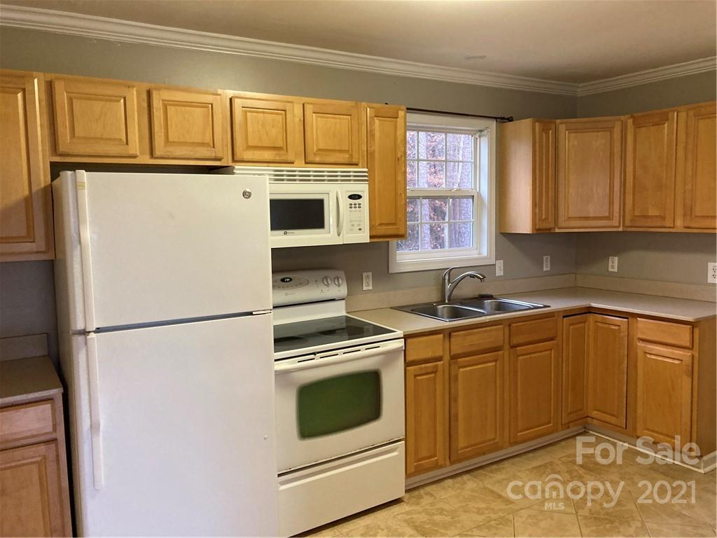 1560 Legion Road Fort Mill, SC 29715 - Photo 4 of 8 a kitchen with stainless steel appliances granite countertop a refrigerator sink and cabinets