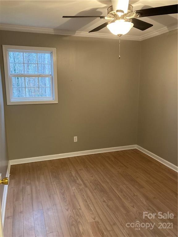 1560 Legion Road Fort Mill, SC 29715 - Photo 6 of 8 an empty room with wooden floor fan and windows