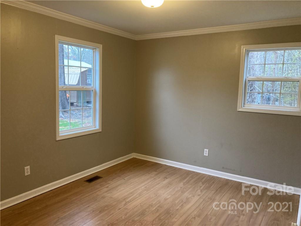 1560 Legion Road Fort Mill, SC 29715 - Photo 7 of 8 a view of an empty room with wooden floor and a window