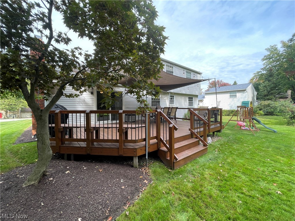 9572 Hoose Road Mentor, OH 44060 - Photo 33 of 35 Rear view of house with a playground, a yard, and a wooden deck