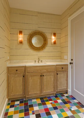 a bed sitting in a spacious bedroom next to a window