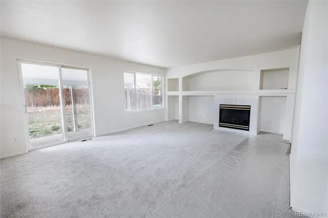 a spacious bathroom with a tub sink and mirror