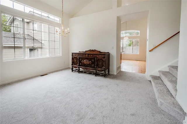 a large kitchen with stainless steel appliances granite countertop a large stove a sink dishwasher and wooden cabinets with wooden floor