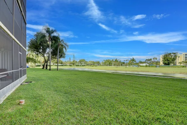 a view of a grassy field with an trees