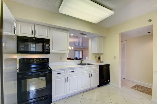 a kitchen with stainless steel appliances a stove microwave and cabinets