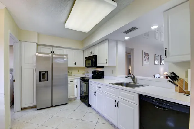 a kitchen with a sink stainless steel appliances and cabinets
