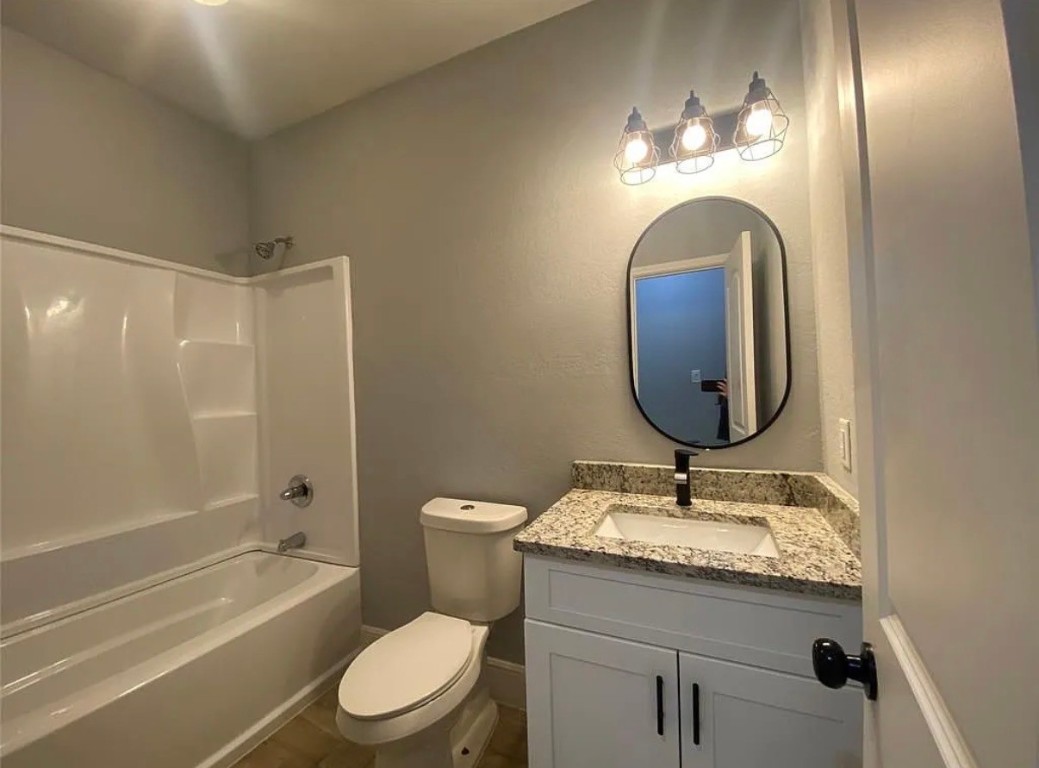 5754 Reed Road, Unit B Houston, TX 77033 - Photo 11 of 15 a bathroom with a toilet sink and mirror