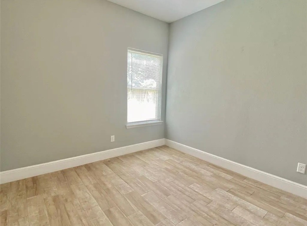 5754 Reed Road, Unit B Houston, TX 77033 - Photo 9 of 15 an empty room with a window