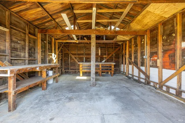 a view of an empty room with wooden roof