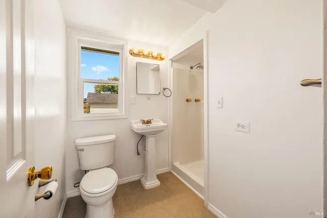 a bathroom with a toilet and a shower