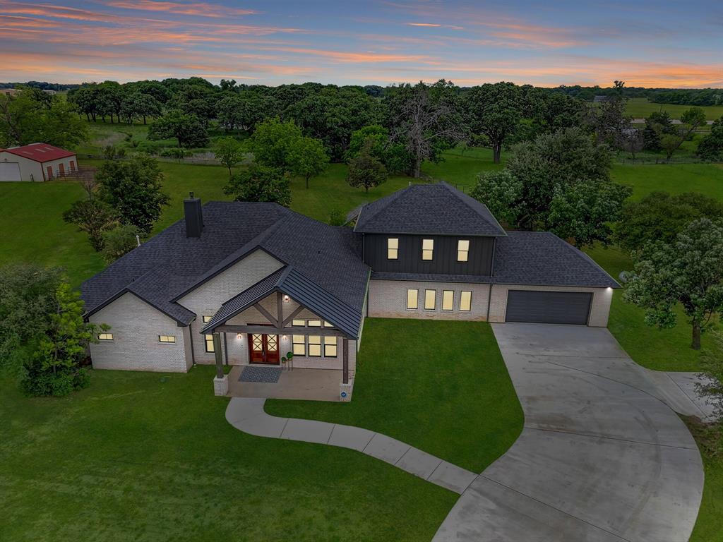 Elegant drive up with extensive concrete drive for additional parking 