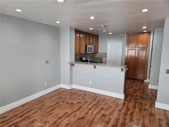a view of a kitchen with a sink and a refrigerator